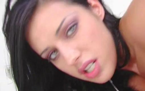 Dark-haired woman speaking with an intent expression.